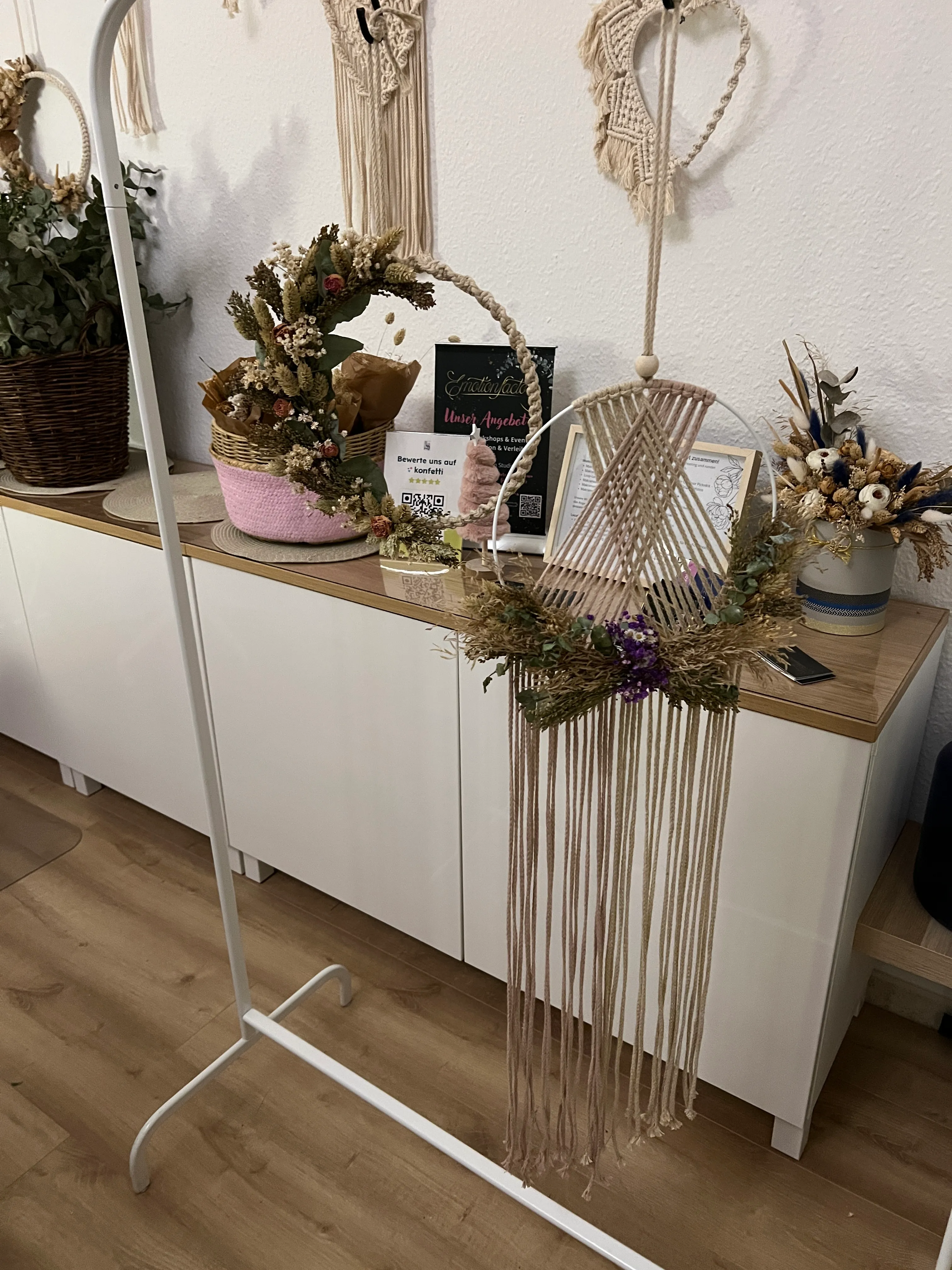 Macramé wall decor with hanging ropes indoors.