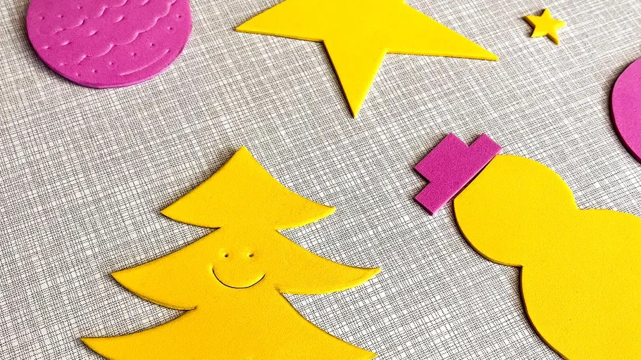 Yellow and pink shapes on a textured surface.