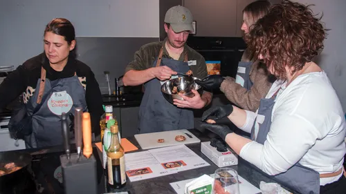 People cooking together in a kitchen.