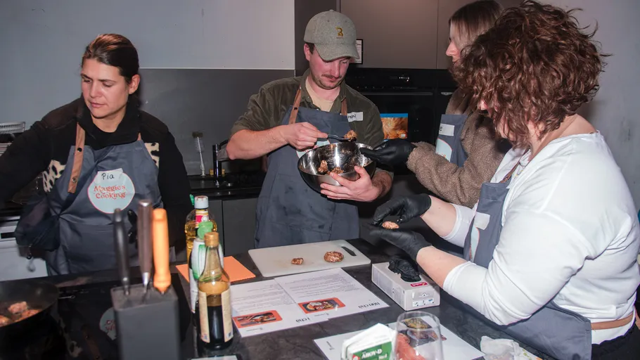 People cooking together in a kitchen.