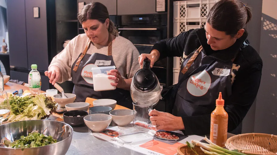 Two women cooking in a kitchen together.