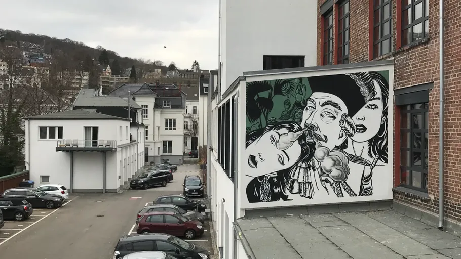 Building mural art in urban parking area.