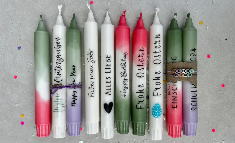 Colorful candles with festive inscriptions, confetti background.