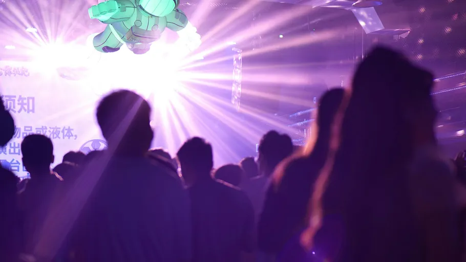 Crowd in nightclub with bright lights.