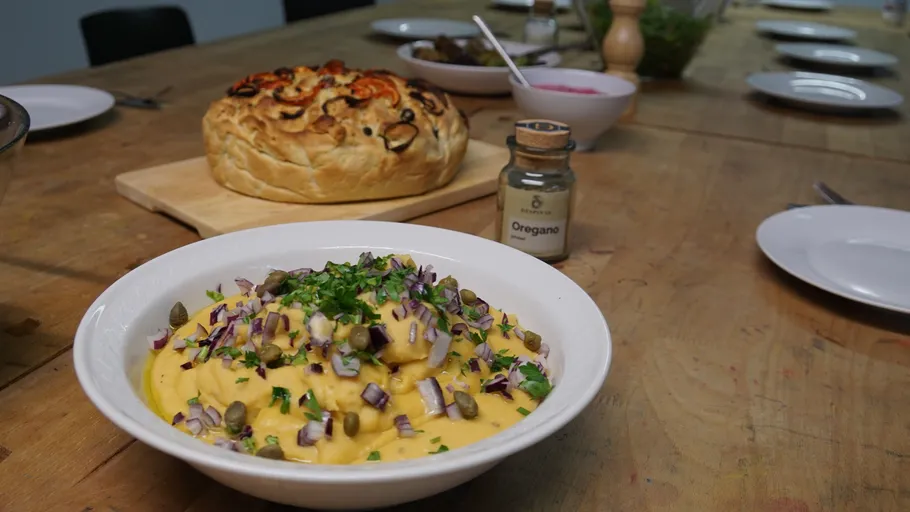 Gerichte auf Holztisch mit Oregano serviert.