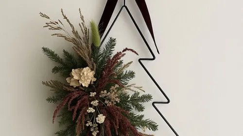 Wire tree-shaped frame with dried floral arrangement.