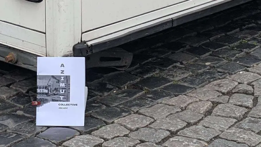 Buch steht auf Kopfsteinpflaster nahe Anhänger.