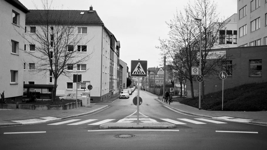 Street with zebra crossing and traffic sign.