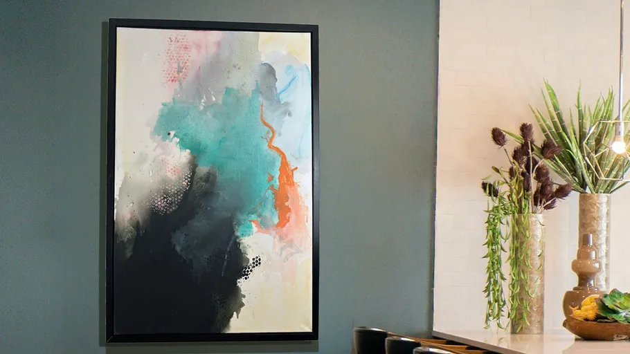 Abstract painting on wall near kitchen counter.