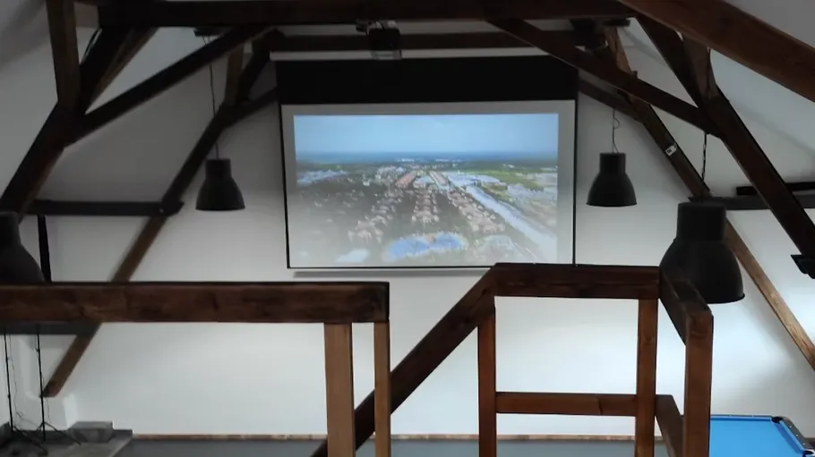 Room with projector screen and wooden beams.