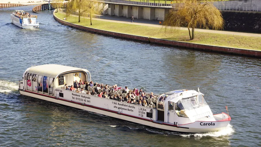 Tour boat carrying passengers on a river.