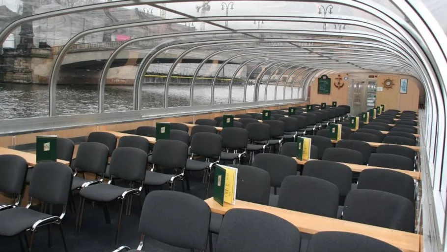 Empty boat interior with rows of chairs.