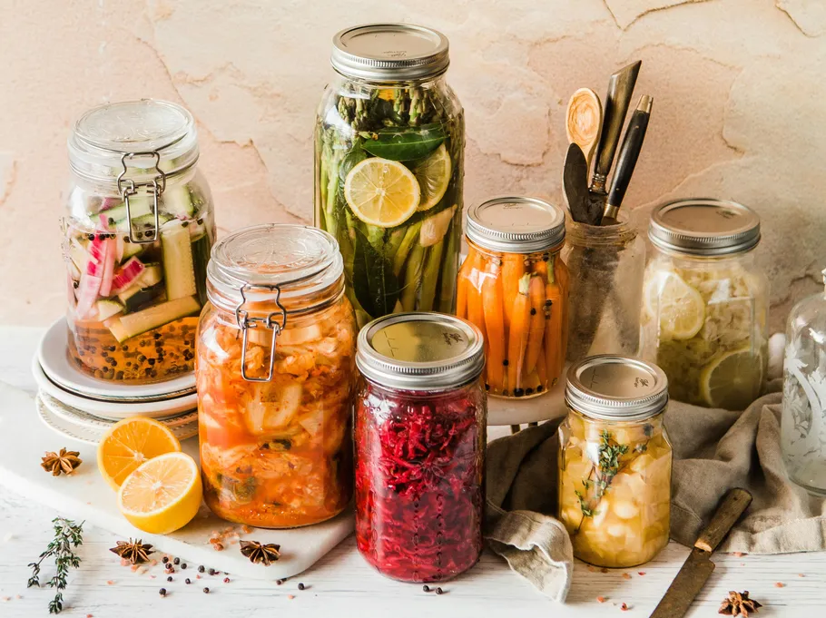 Jars of pickled vegetables on a table.