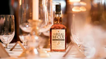 Rum bottle on elegant dining table.