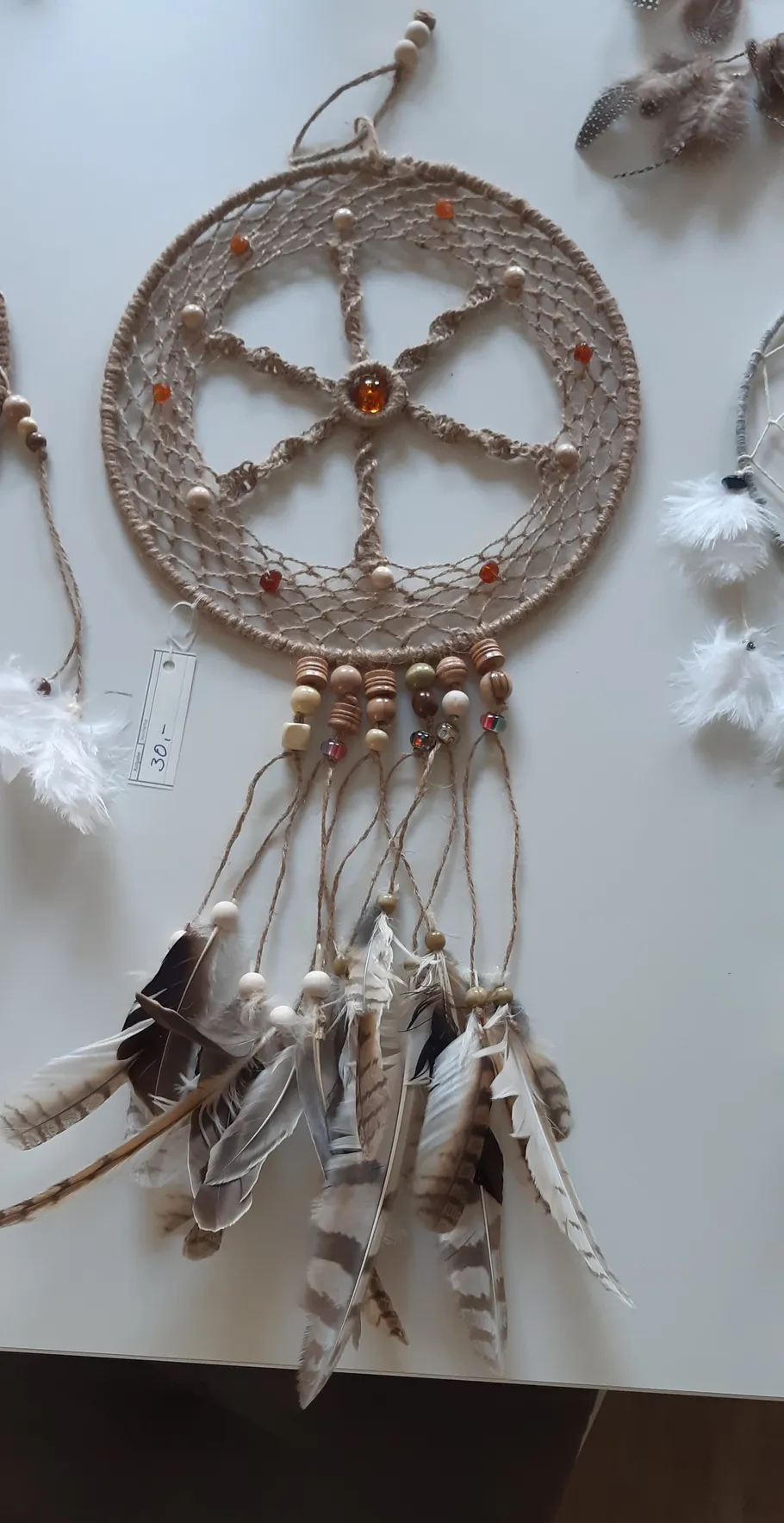Dreamcatcher with feathers on a table.