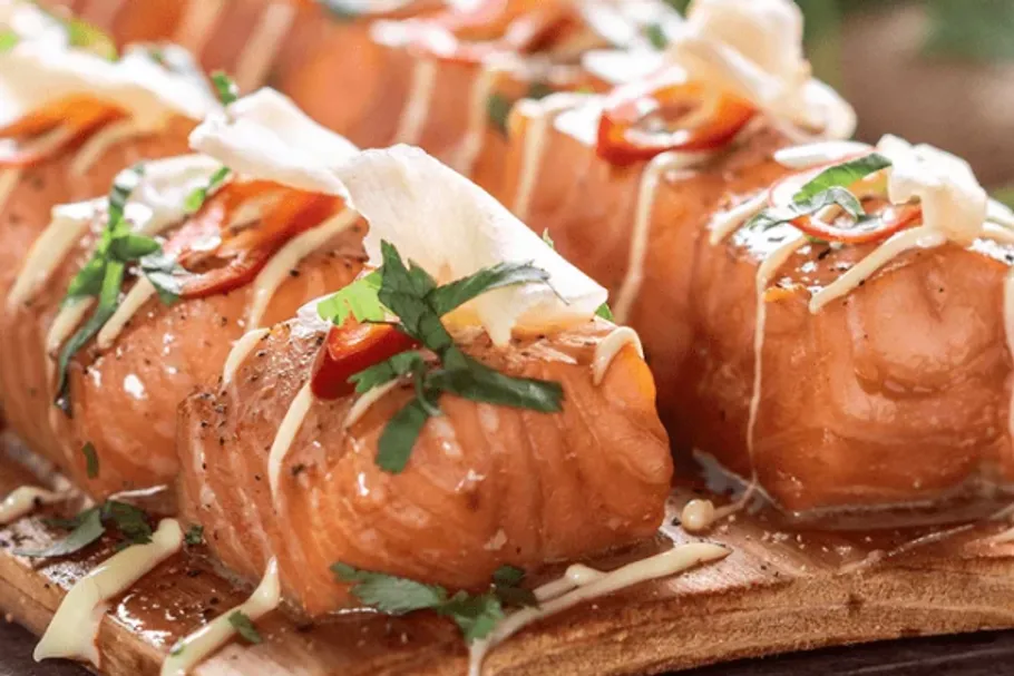 Grilled salmon with garnish on a plate.