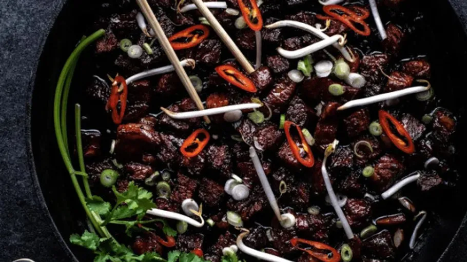 Stir-fried beef with vegetables in a pan.