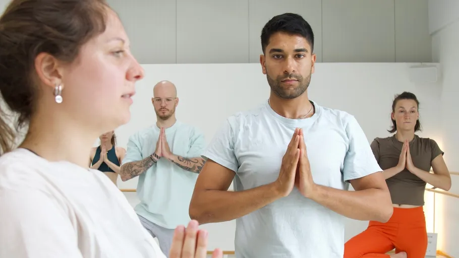 People practicing yoga in a studio.