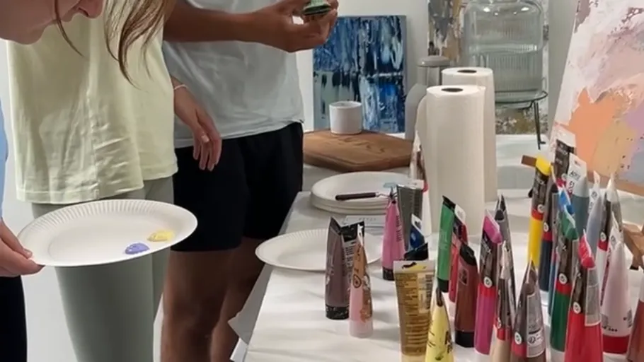 People selecting paints in an art studio.
