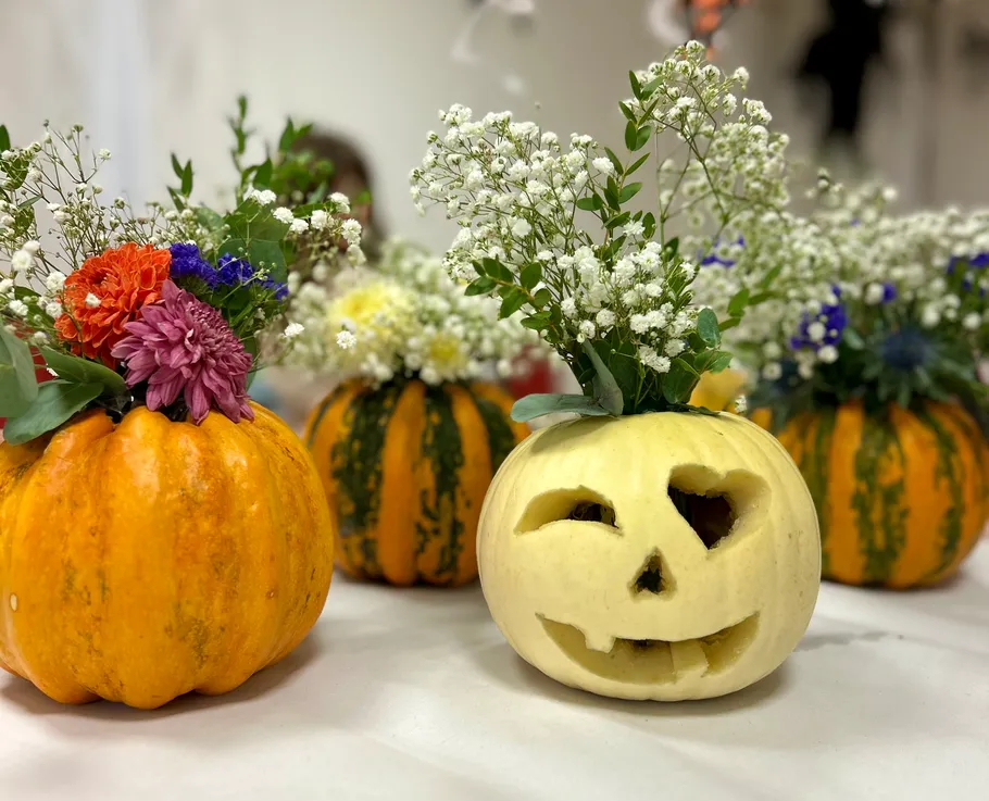 Pumpkins with flowers used as festive decorations.