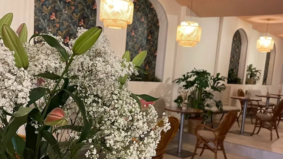 Flowers in a decorated café interior.