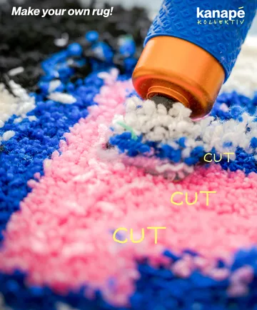Tool tufting colorful yarn into a rug.