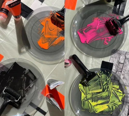 Colorful paint rollers on transparent plates.