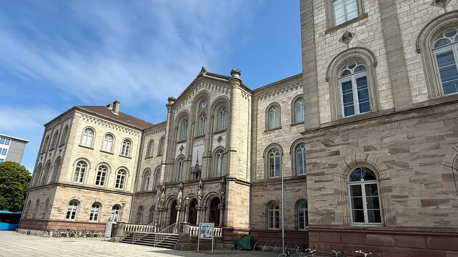 Historic building with arches and windows, exterior view.