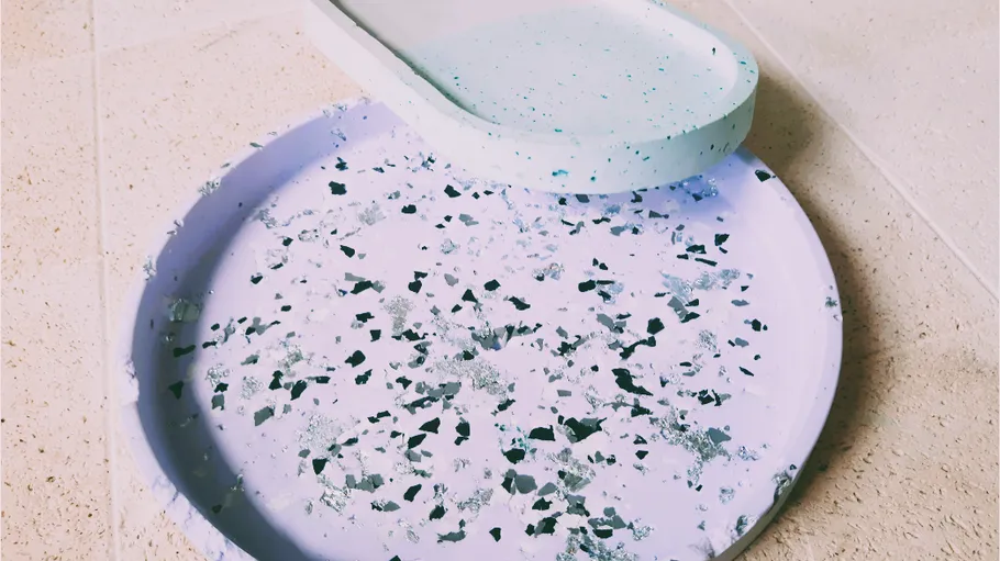 Terrazzo tray and dish on tiled surface.