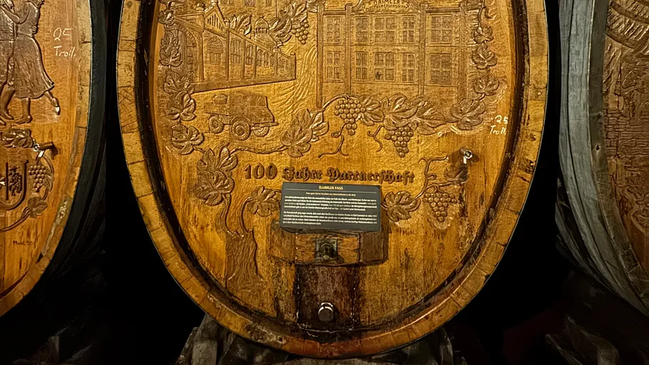 Wooden barrel with engraved design and text.