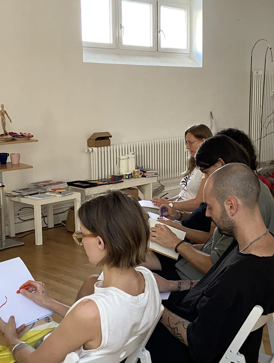 People drawing in a classroom setting.