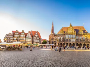Market square with historic buildings and lots of people.