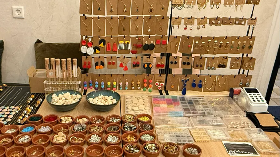 Colorful earrings displayed on tables.