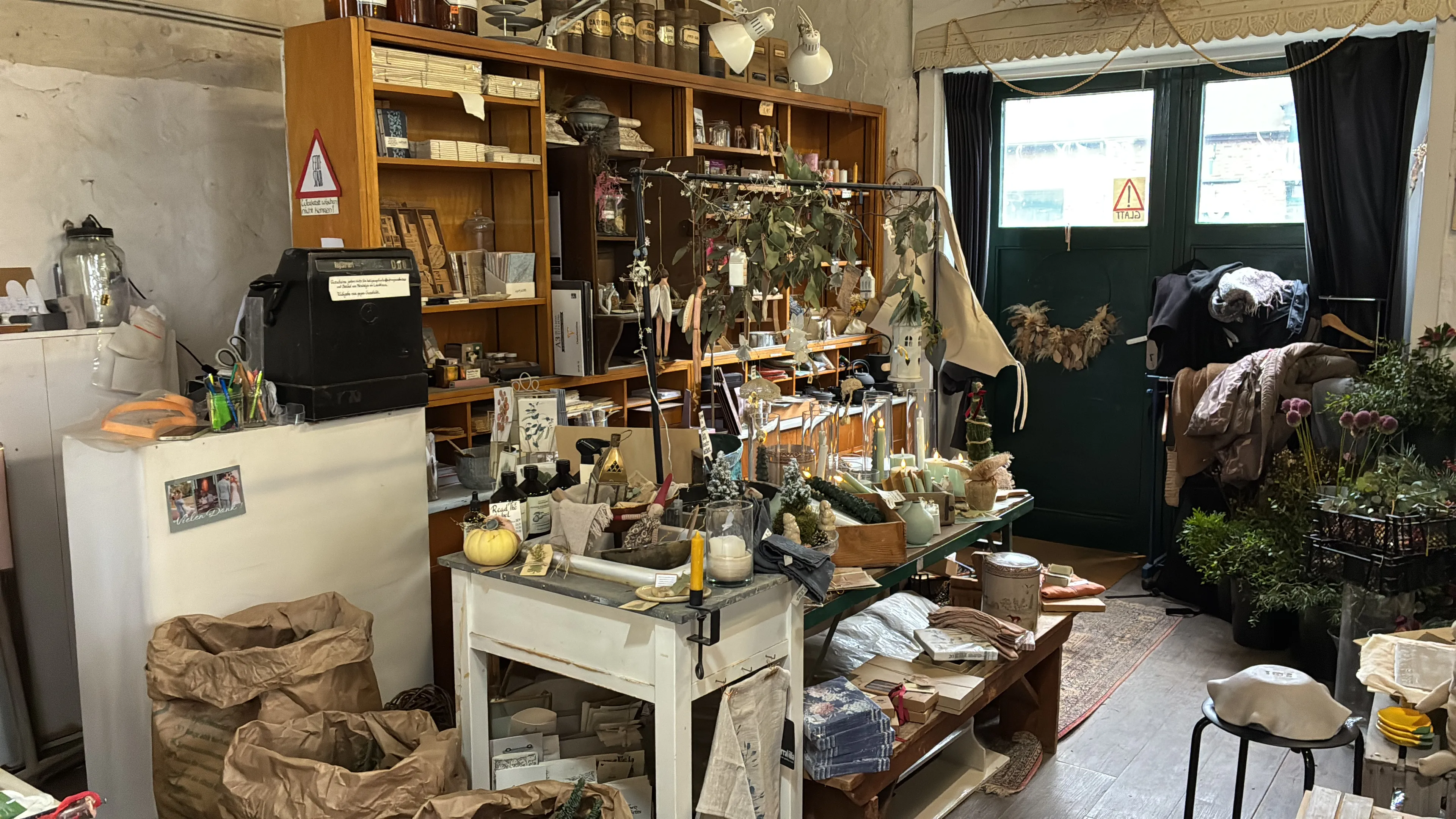 Quaint shop with vintage decor and plants.