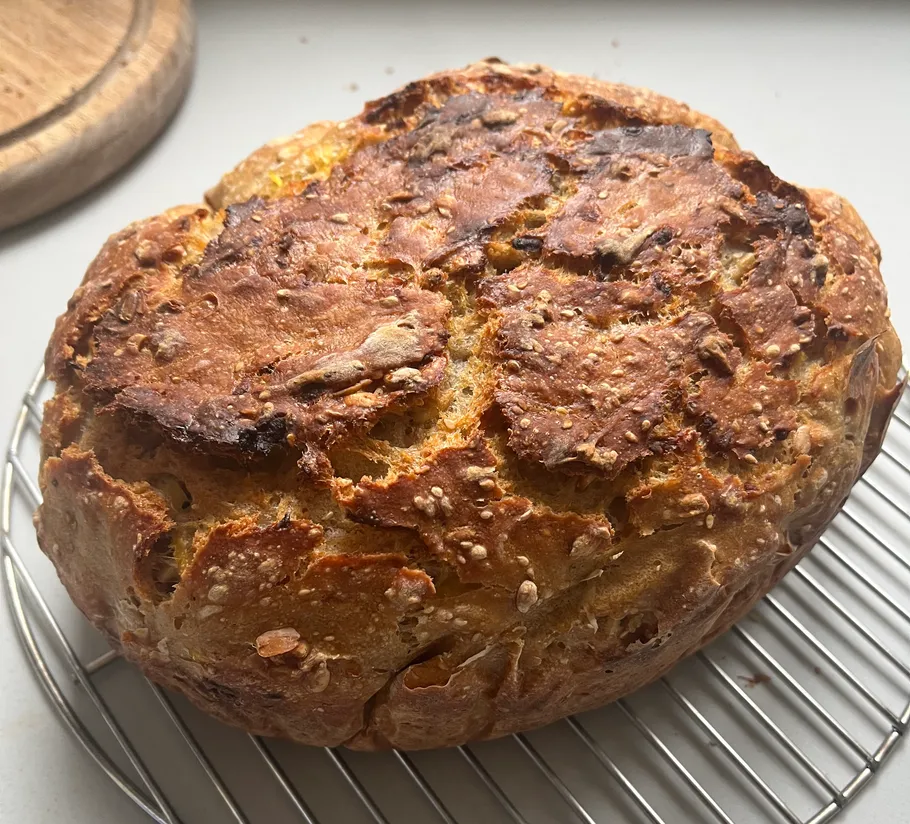 Rundes, knuspriges Brot mit Samen auf Abkühlgitter.
