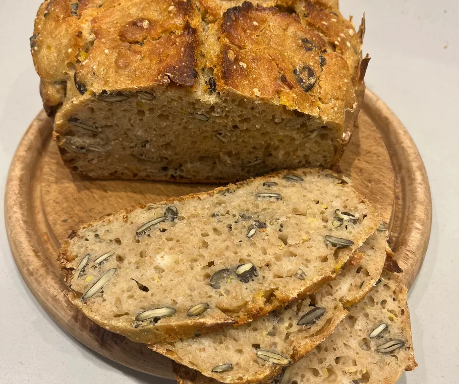Sliced multigrain bread with seeds on plate.