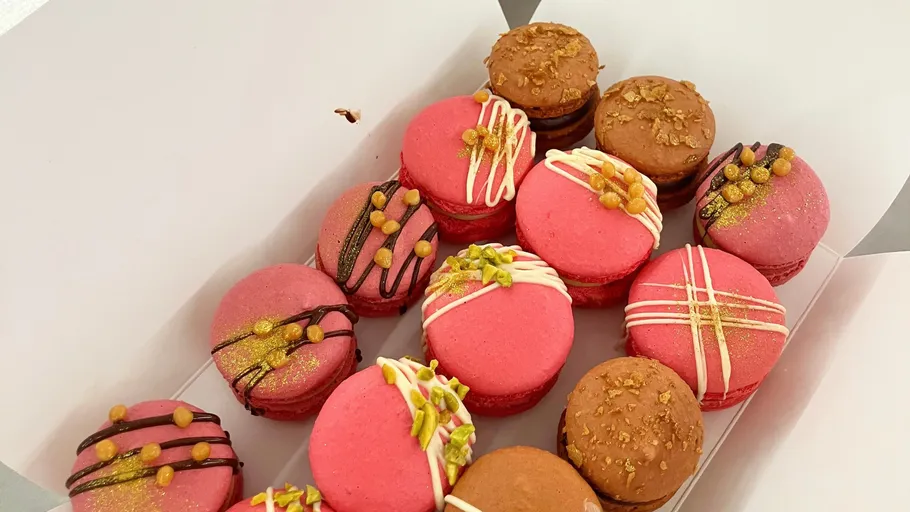 Decorated macarons in an open box.