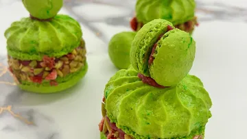 Green macarons with nut and fruit filling.