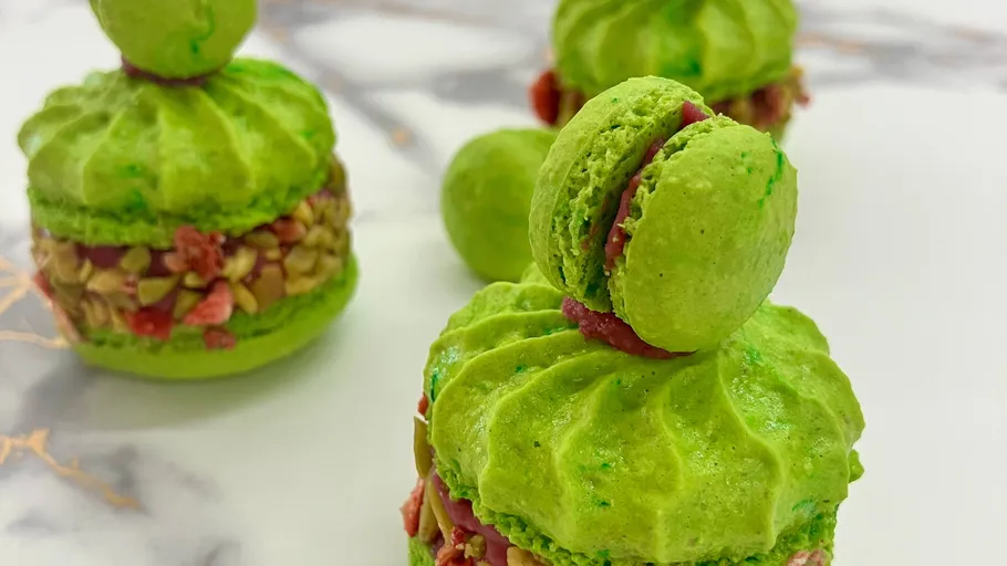 Green macarons with nut and fruit filling.