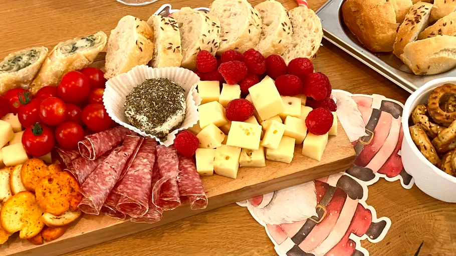 Charcuterie board with bread, cheese, fruit.