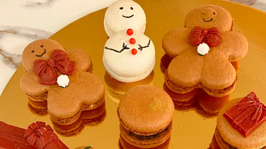 Decorative macarons shaped like gingerbread and snowman.