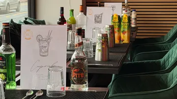Bottles and glasses on a table, cafe setting.