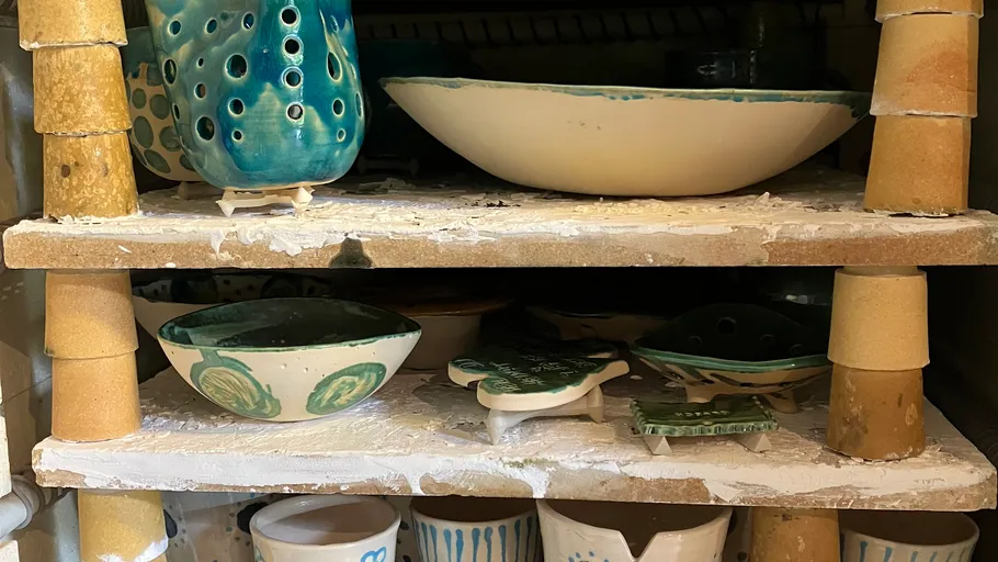 Ceramic pottery on kiln shelves.