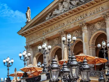 Historic building with illuminated lanterns and umbrellas.