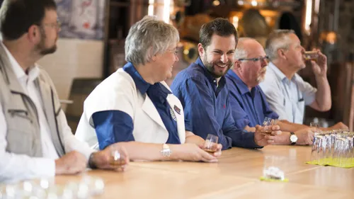 People tasting drinks in a bar setting.