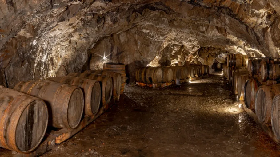 Barrels in a rocky wine cellar cave.