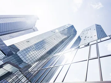 Skyscrapers reflect sunlight in urban environments.
