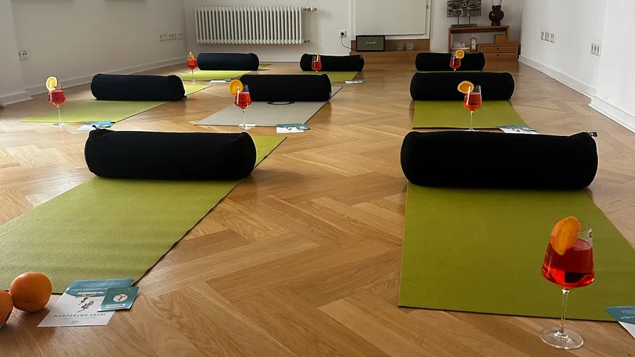 Yoga mats with drinks in a studio.