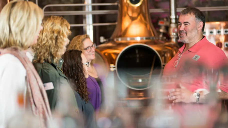 Man giving tour to group in distillery.