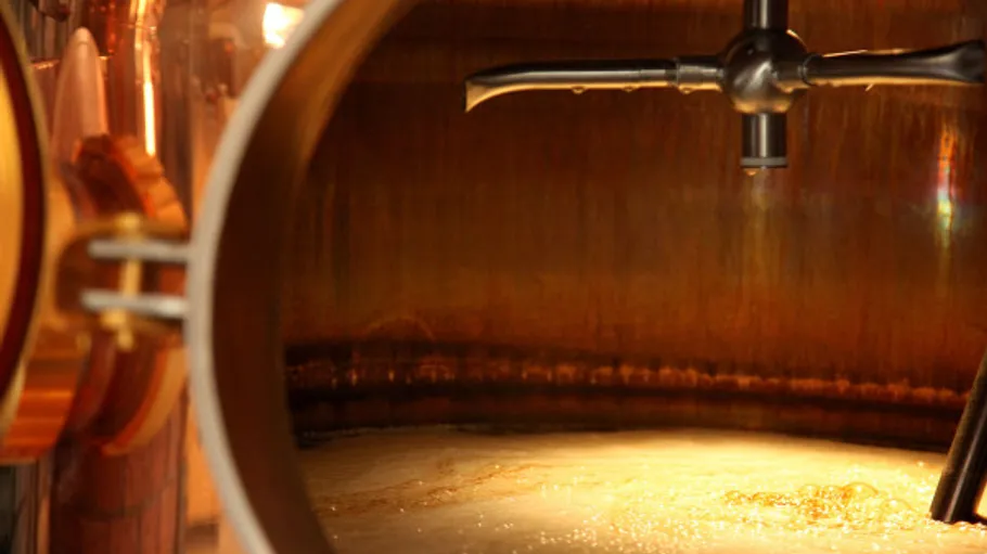 Copper brewing vat with liquid inside.